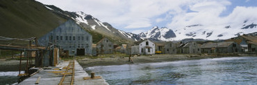 Abandoned Station in Front of Snowcapped Mountains, Whaling Station, St. George Island, Alaska, USA