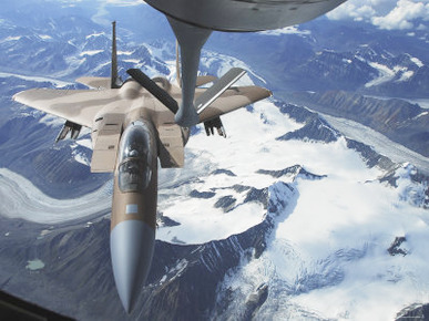 F-15C Eagle Aircraft from behind a KC-135R Stratostanker over the Pacific Alaskan Range