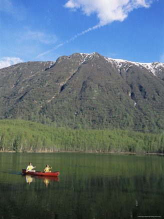 Man and Woman Canoeing in Mirror Lake, Chugach Mountains, Anchorage, Alaska, USA