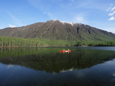 Man and Woman Canoeing in Mirror Lake, Chugach Mountains, Anchorage, Alaska, USA